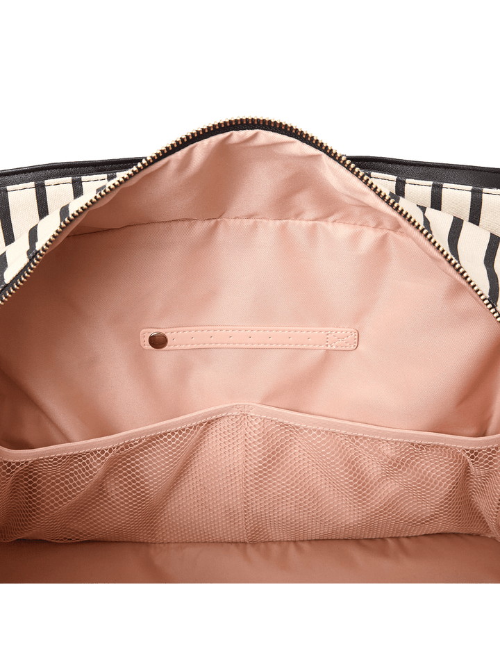 Close up of the pockets and jewelry tab inside a travel bag