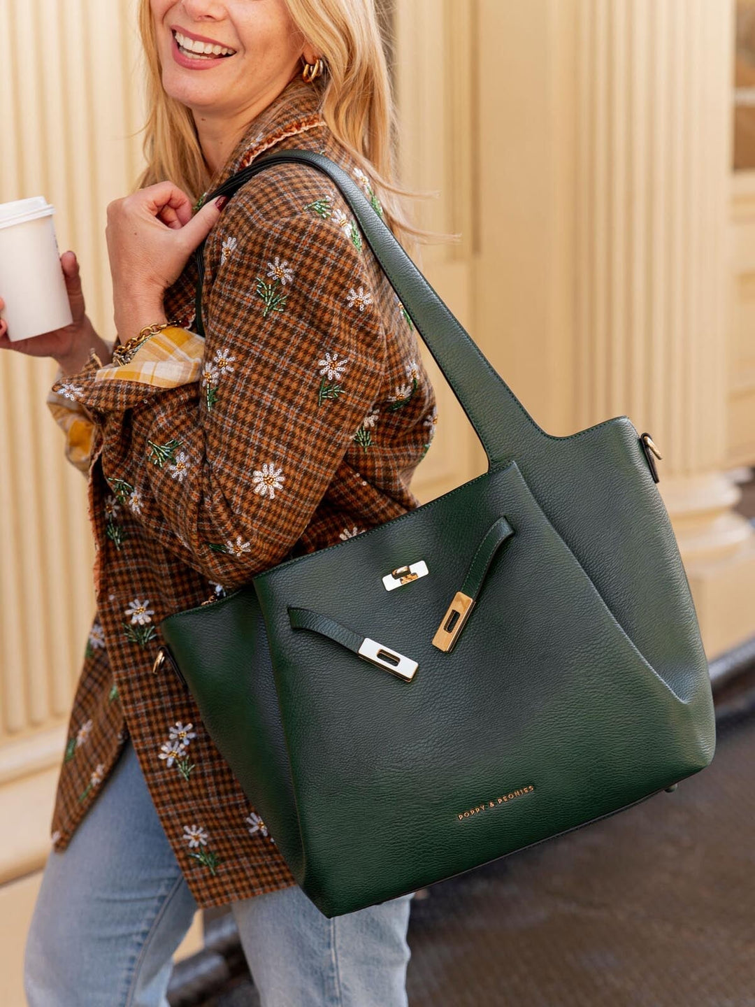 Woman holding a green handbag with a blurred background