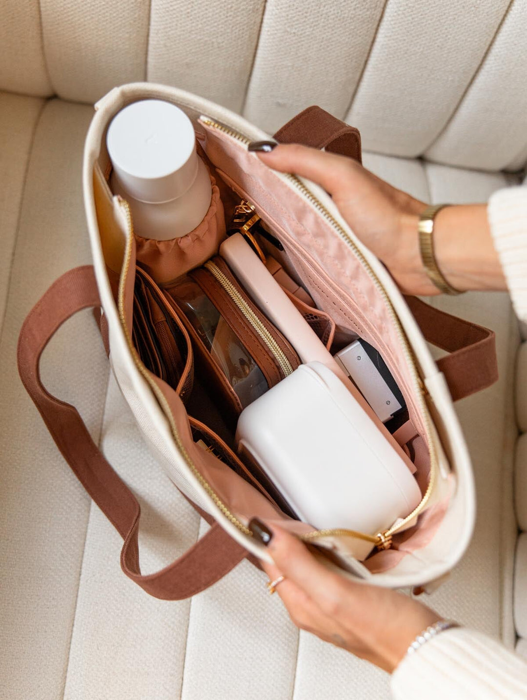 Open interior of Poppy & Peonies The Small Signature Tote in Chestnut, showing blush pink lining, organized compartments, a water bottle and everyday essentials.