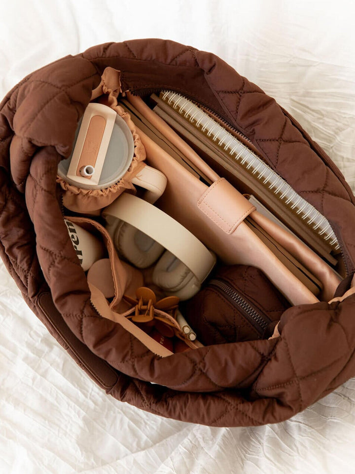 Brown quilted bag on a white background